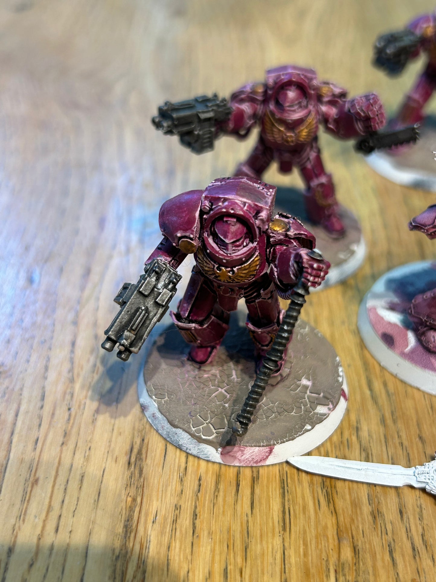 Emperor’s children Horus Heresy terminators (I believe they’re the earlier forge world ones). Missing one head and the banner pole