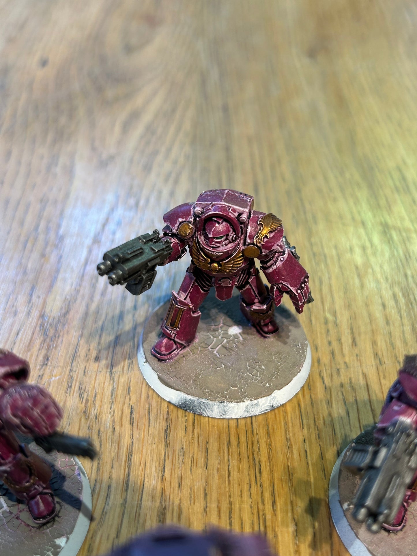 Emperor’s children Horus Heresy terminators (I believe they’re the earlier forge world ones). Missing one head and the banner pole