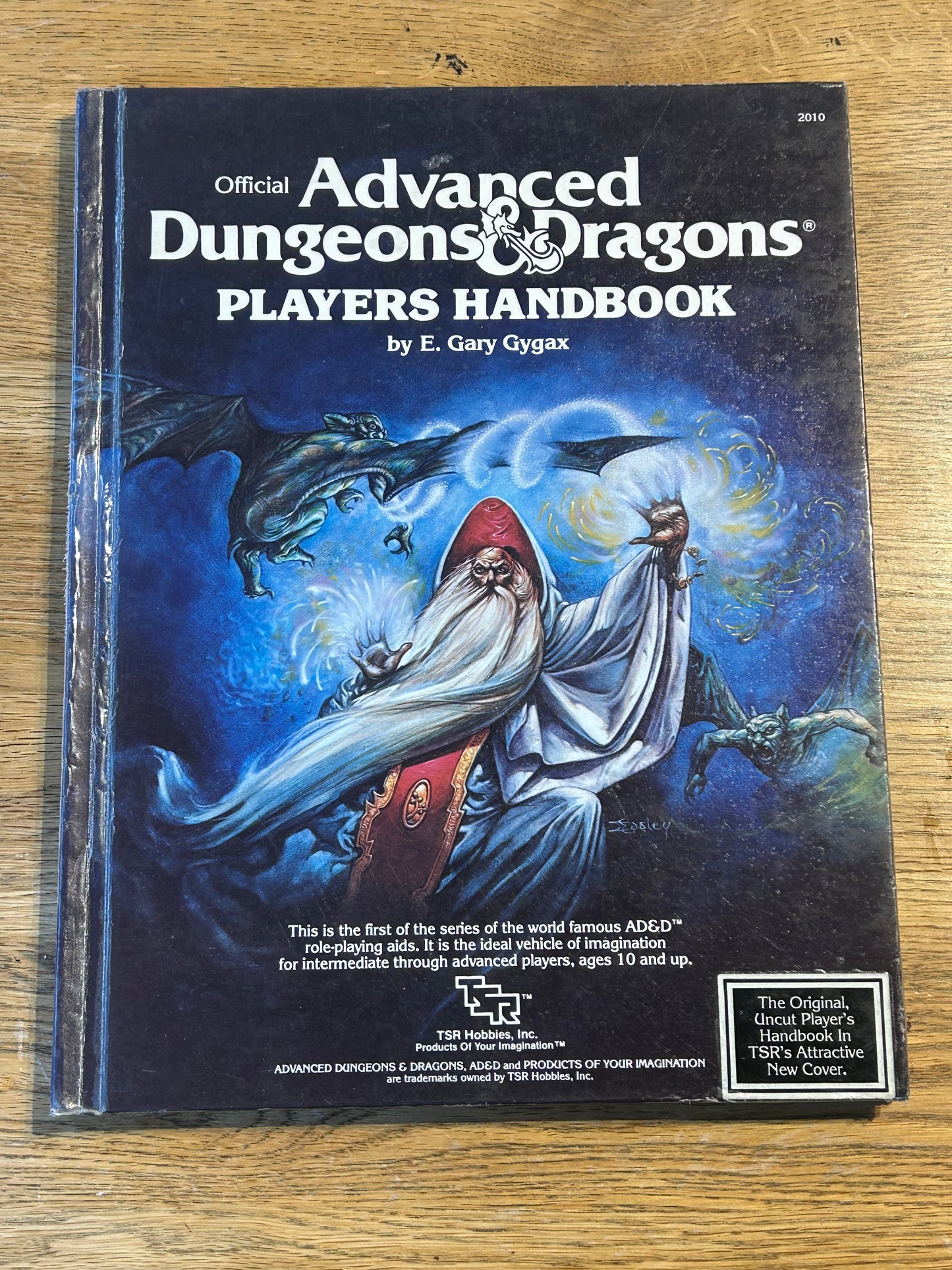Ad&D Players Handbook Dungeons and Dragons (has been coated in a layer of plastic wrap to protect the book and has the previous owner’s name in it)