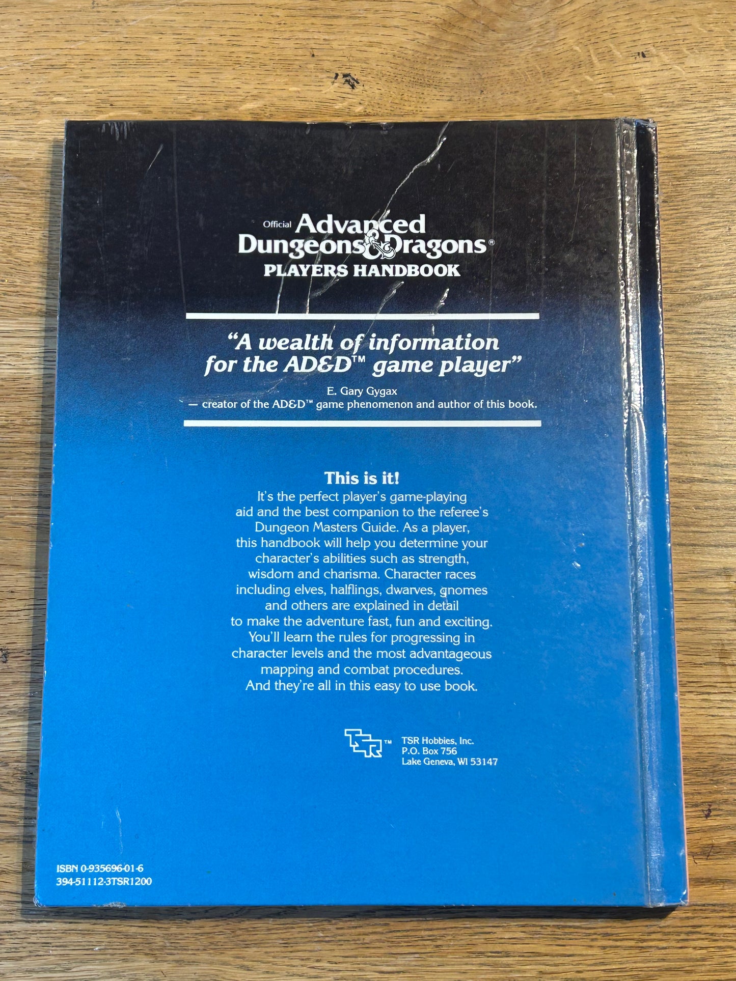 Ad&D Players Handbook Dungeons and Dragons (has been coated in a layer of plastic wrap to protect the book and has the previous owner’s name in it)