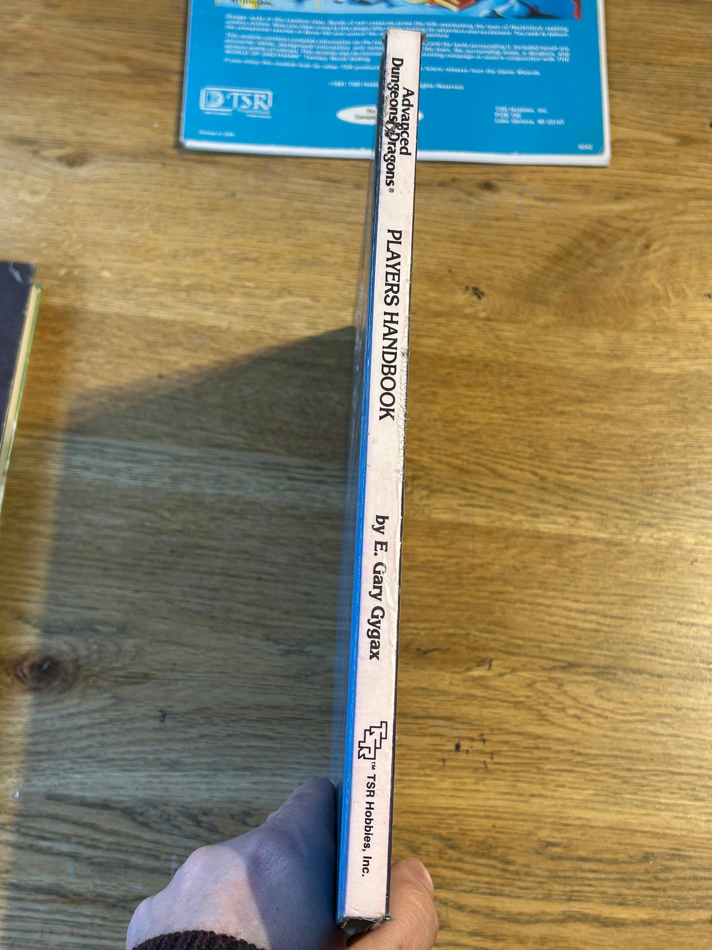 Ad&D Players Handbook Dungeons and Dragons (has been coated in a layer of plastic wrap to protect the book and has the previous owner’s name in it)