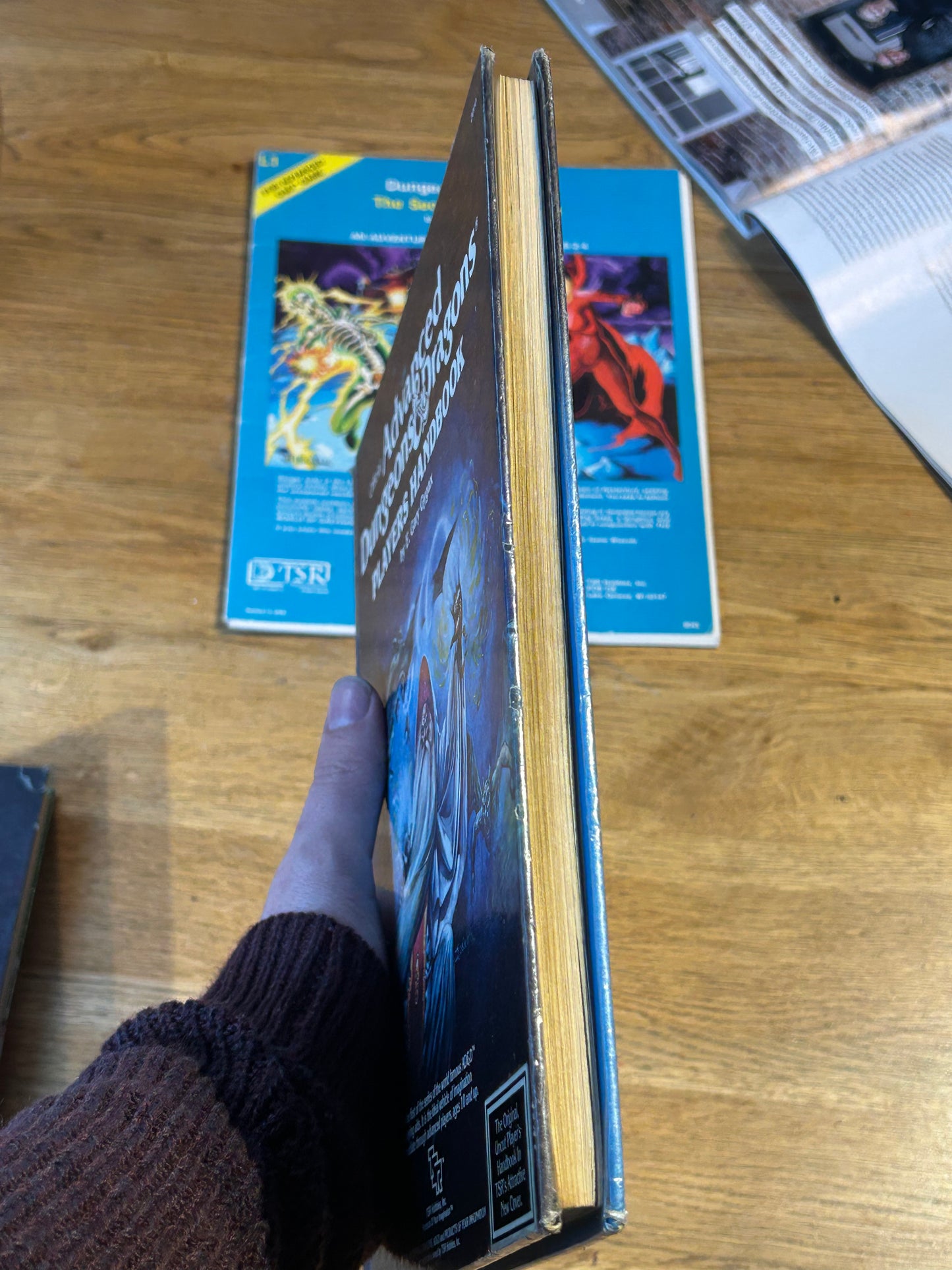 Ad&D Players Handbook Dungeons and Dragons (has been coated in a layer of plastic wrap to protect the book and has the previous owner’s name in it)