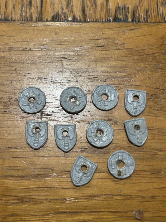 Warhammer fantasy dwarf shields (they’ve had a hole drilled in the middle of them)